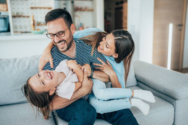A family laughing and playing together at home